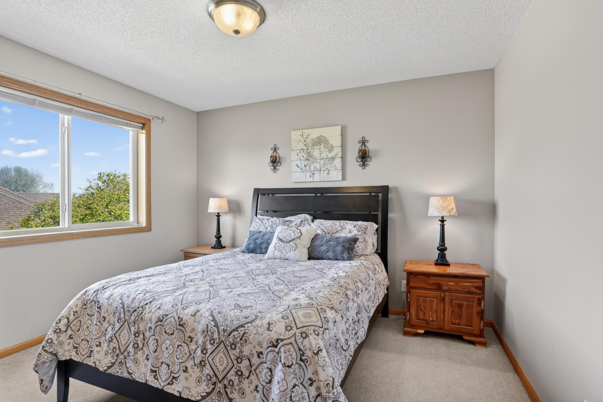 Spacious secondary bedroom with neutral finishes and generous closet space