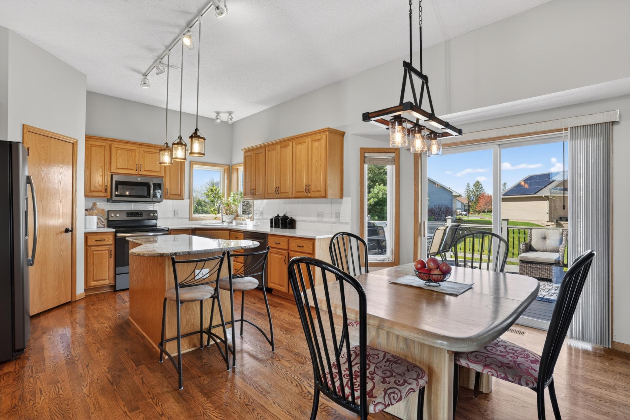 Spacious kitchen and dining area with center island and access to the maintenance-free deck