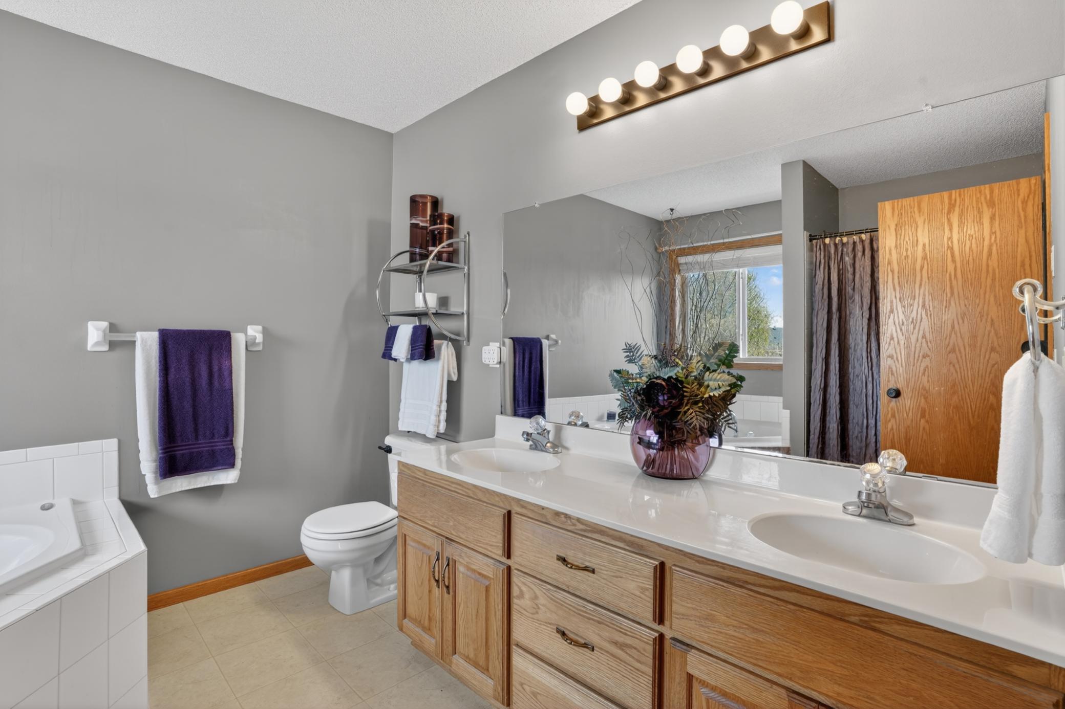 Primary bath with double vanity, soaking tub, and separate shower for everyday comfort