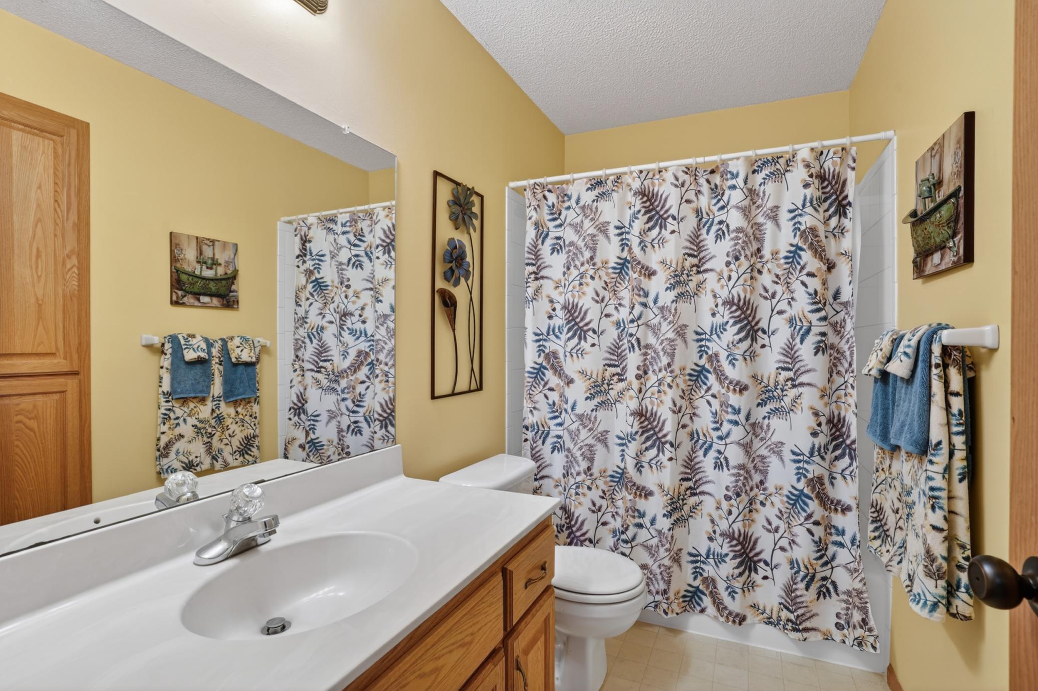 Full upper-level guest bath with oversized vanity and convenient tub/shower combination