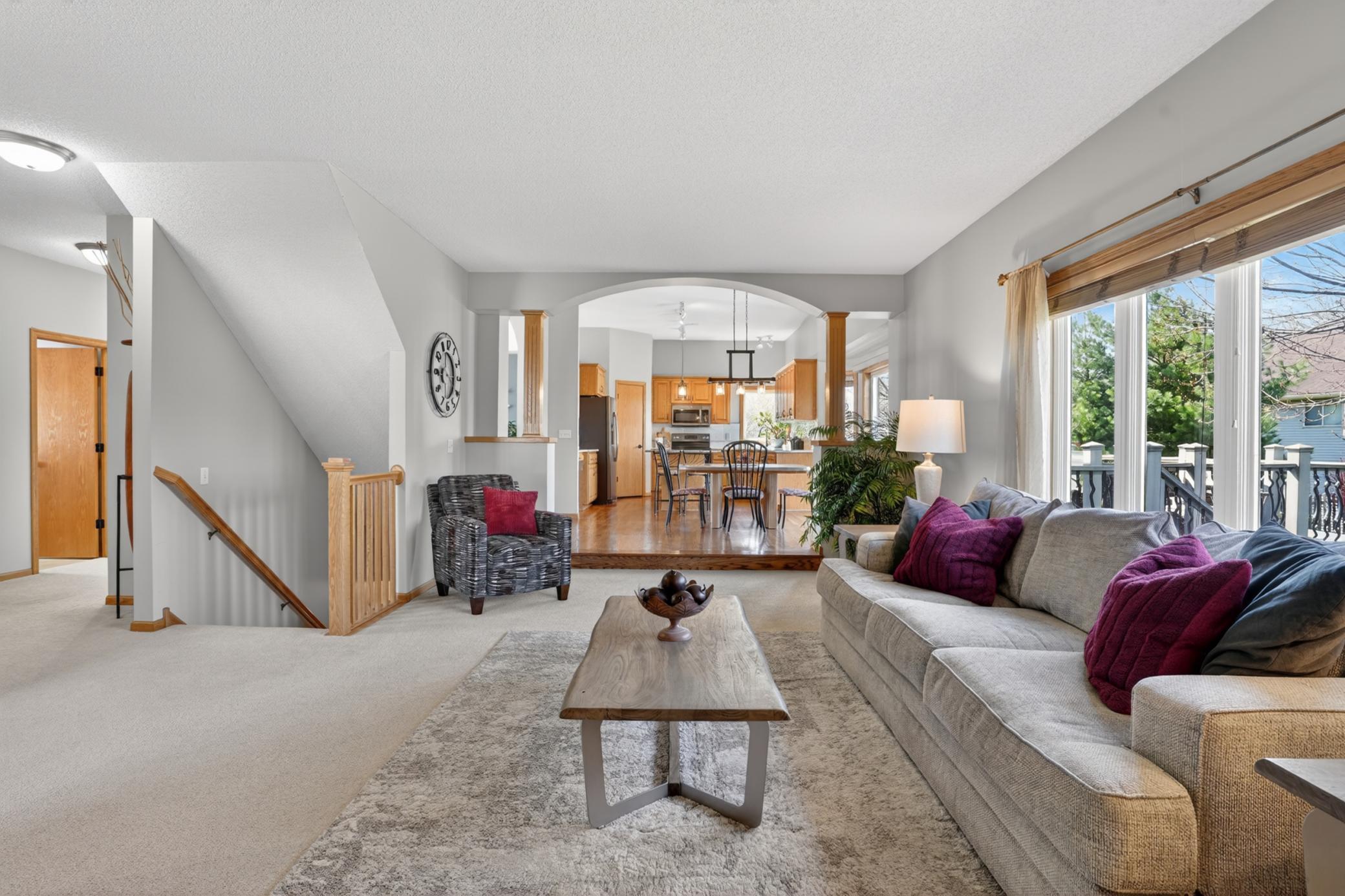 Open main-level layout connecting family room, dining, and kitchen spaces