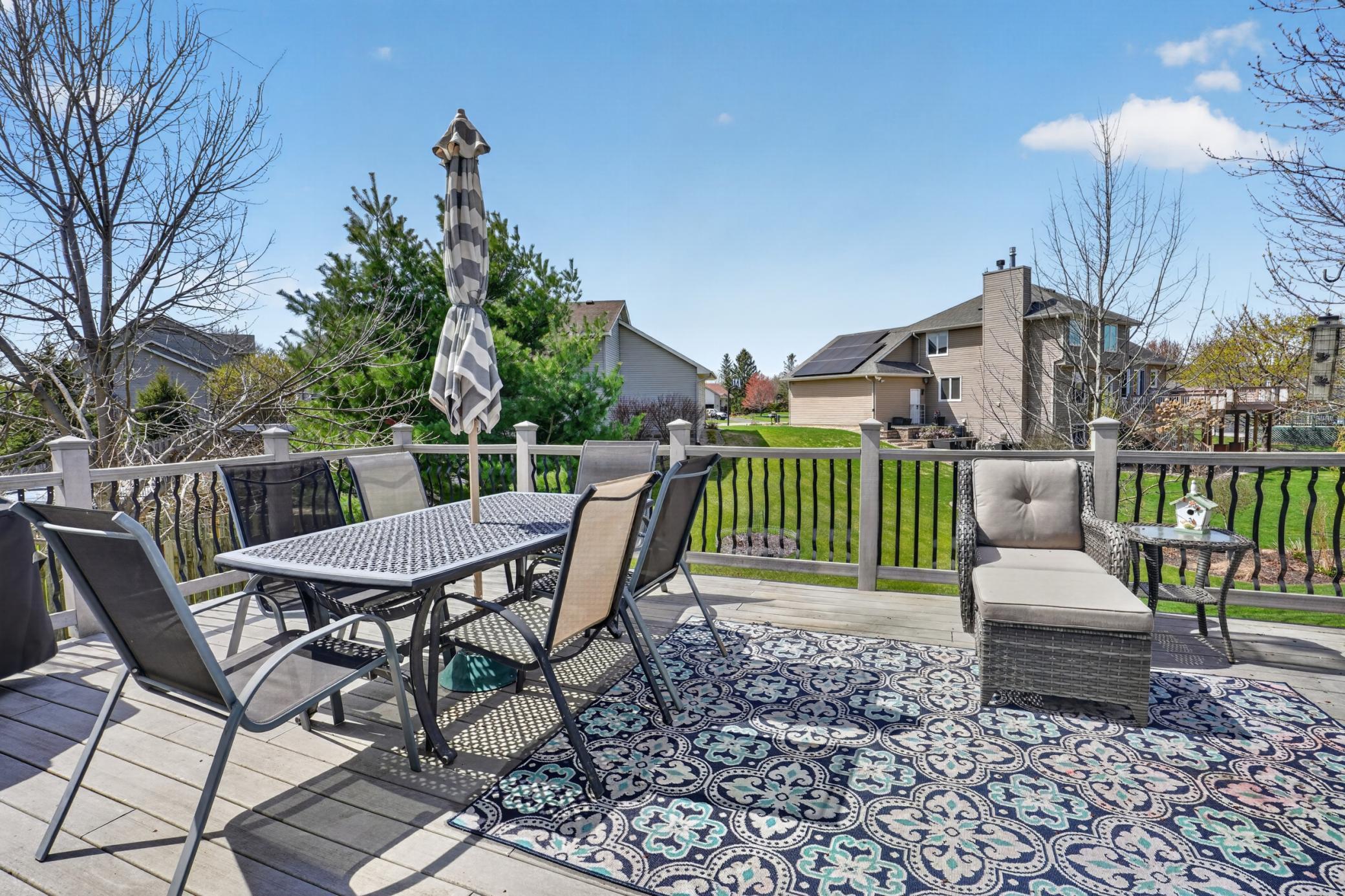 Additional deck view overlooking the spacious backyard and peaceful open green space
