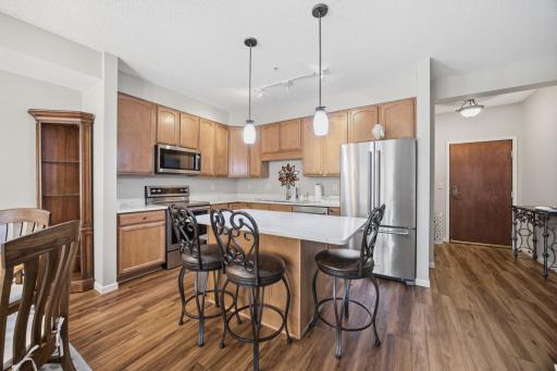 The kitchen is fabulous with the updated stainless steel appliances, sink and faucet, handles on the drawers and cabinets, pendant lights and the gorgeous quartz countertops. The kitchen may be your favorite room!