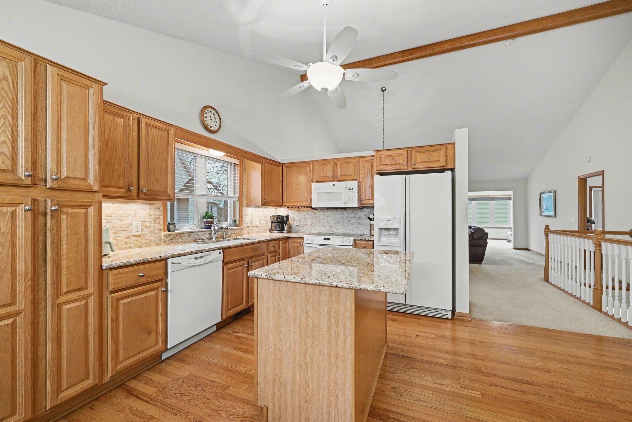 Towering vaulted ceilings, view from the front entrance towards the family room and the 4 season porch.