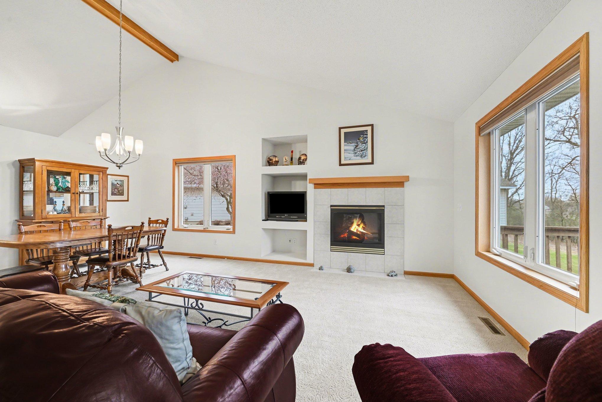 Gas fireplace and the double sized window that overlooks the wooded back yard.