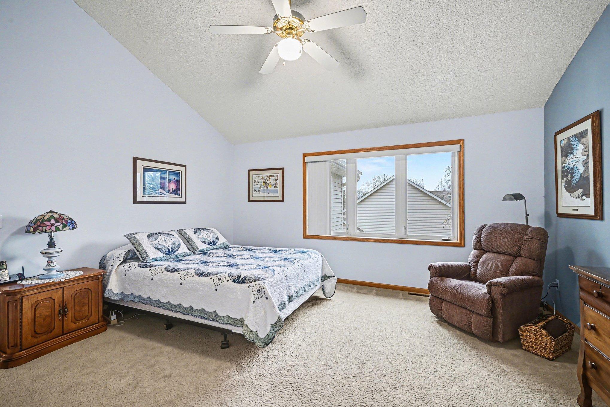 Primary bedroom with vaulted ceiling.