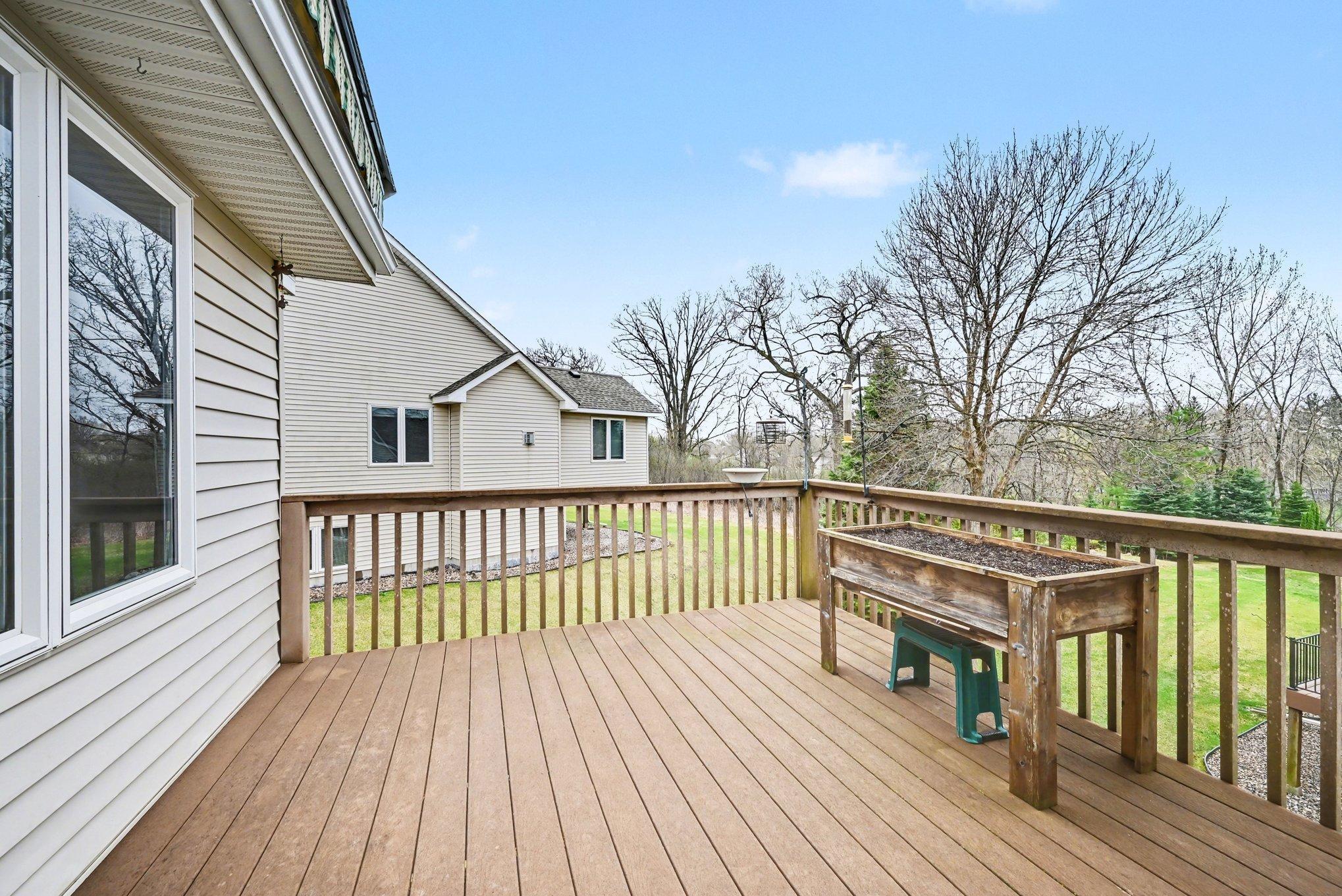 Wooded backyard , and a motorized awning for those hot summer days.