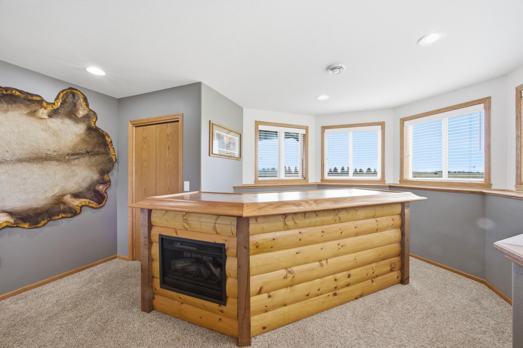 bar with fireplace and bev fridge