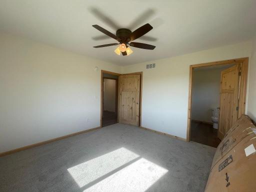 Primary bedroom with 3/4 bath and walk-in closet.