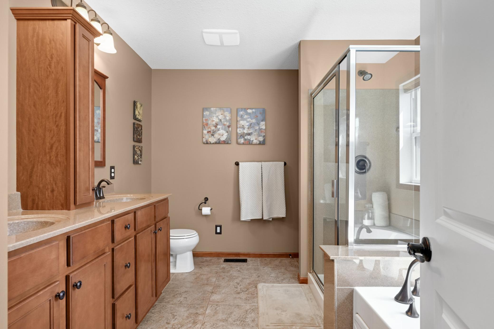 Primary bathroom with double sinks, bath tub and separate shower