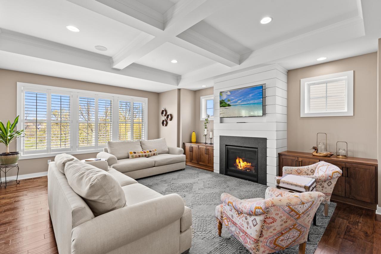 The main-floor family room features built-ins and coffered ceilings.