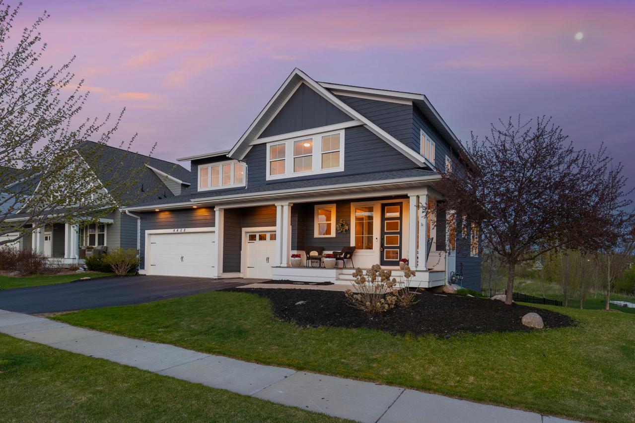 Professionally landscaping frames the cozy porch.