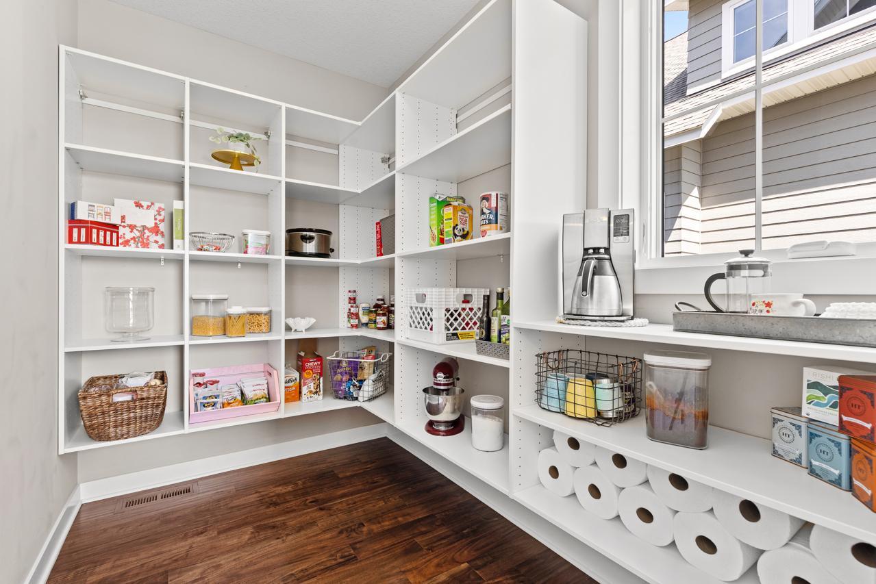 Large walk-in pantry with an abundance of storage space.