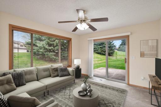 Relax in the bright Sunroom with sliders to patio! (virtually staged)