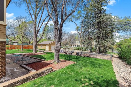 A detached, 2-car garage sits at the edge of the alley with sidewalk to the house.