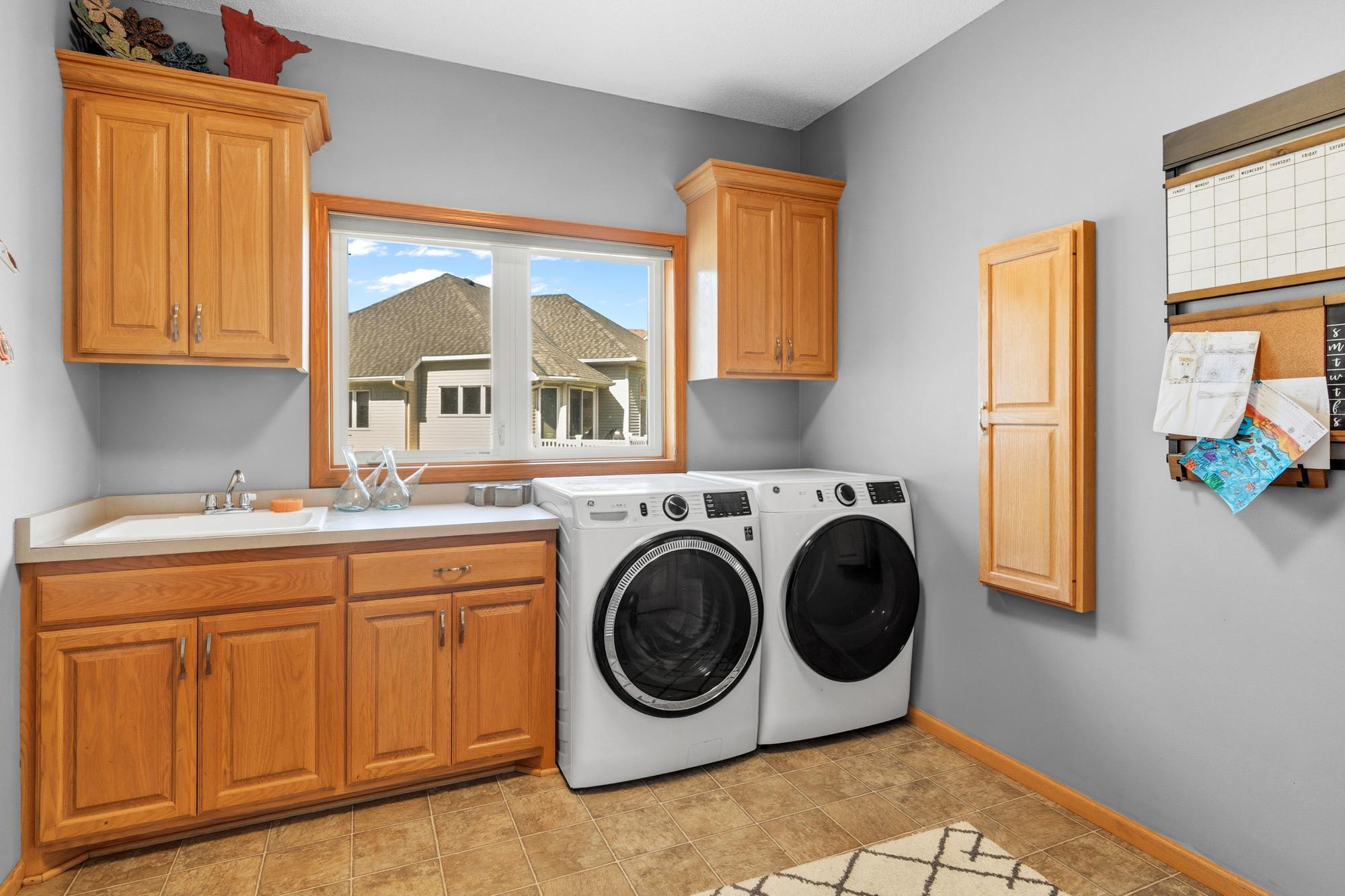 The spacious Laundry Room has cabinet storage and counter space. The Washer and Dryer were new in 2025.