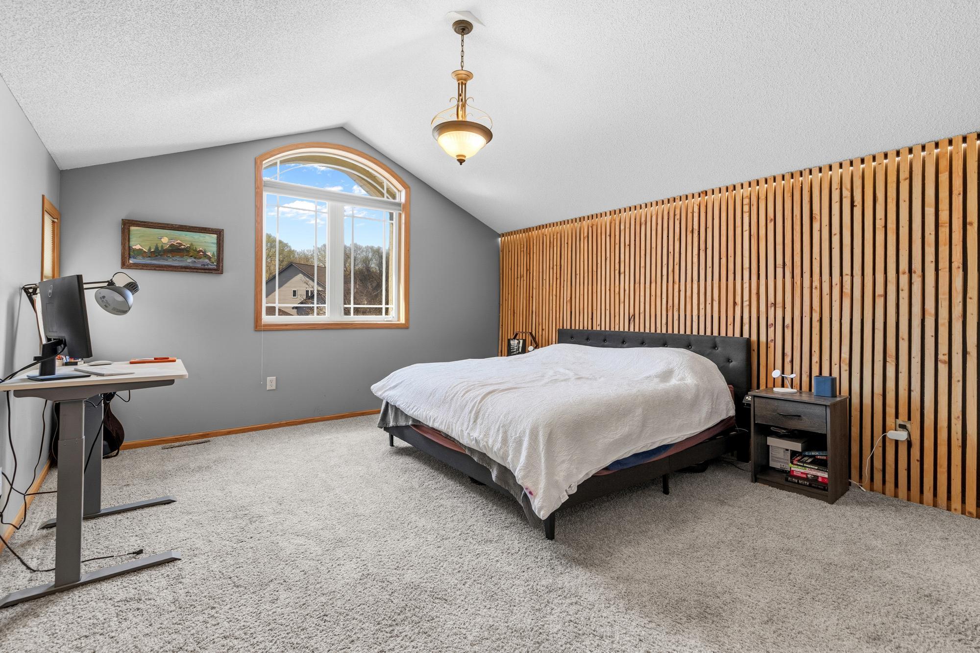 The generously-sized Primary Bedroom features vaulted ceilings and a lighted wall. This is your own private retreat. Complete with a custom Walk-in Closet.
