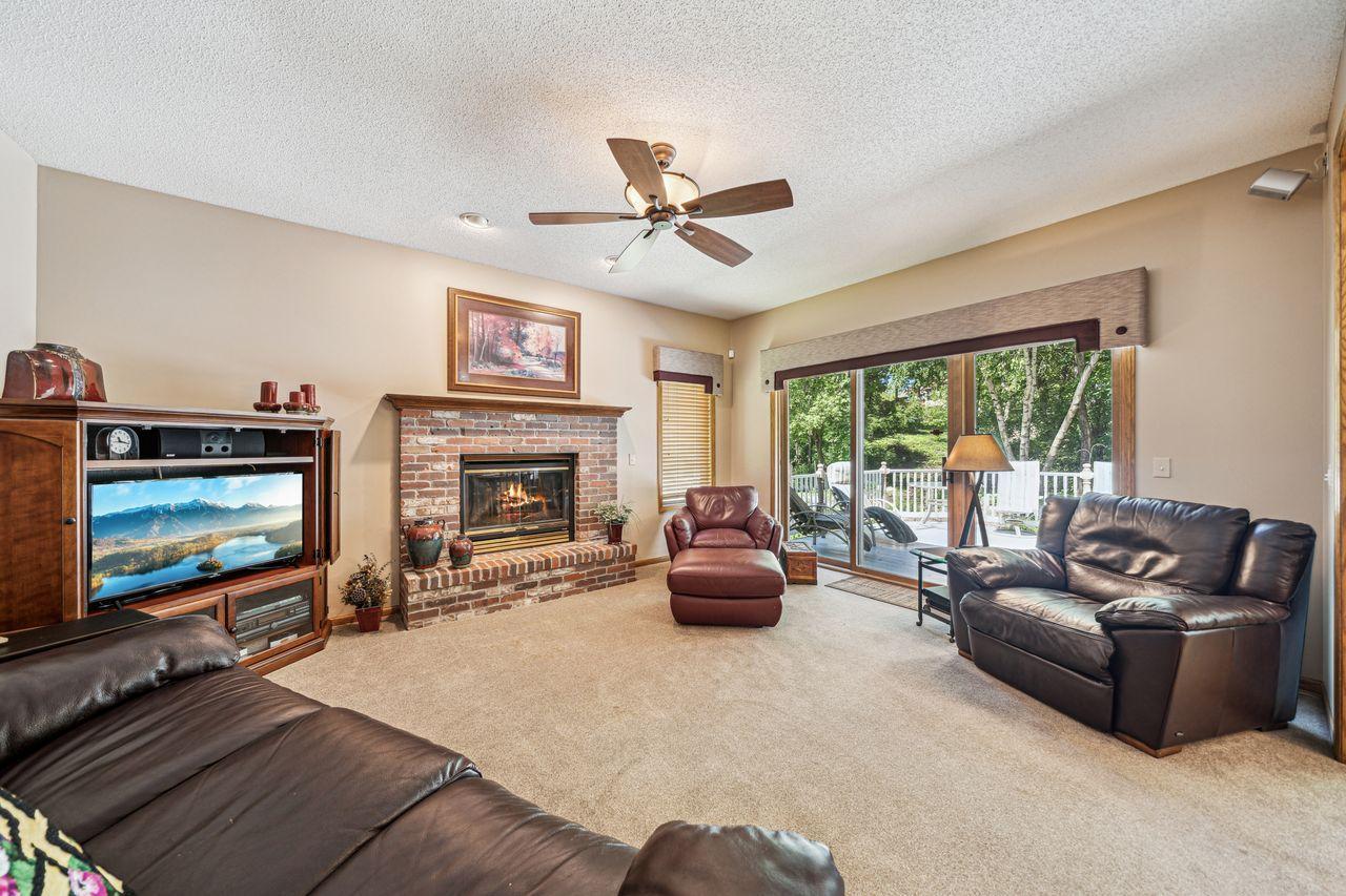 Wonderful Sun Room off the informal dining area has another fireplace and patio door out to maintenance free deck