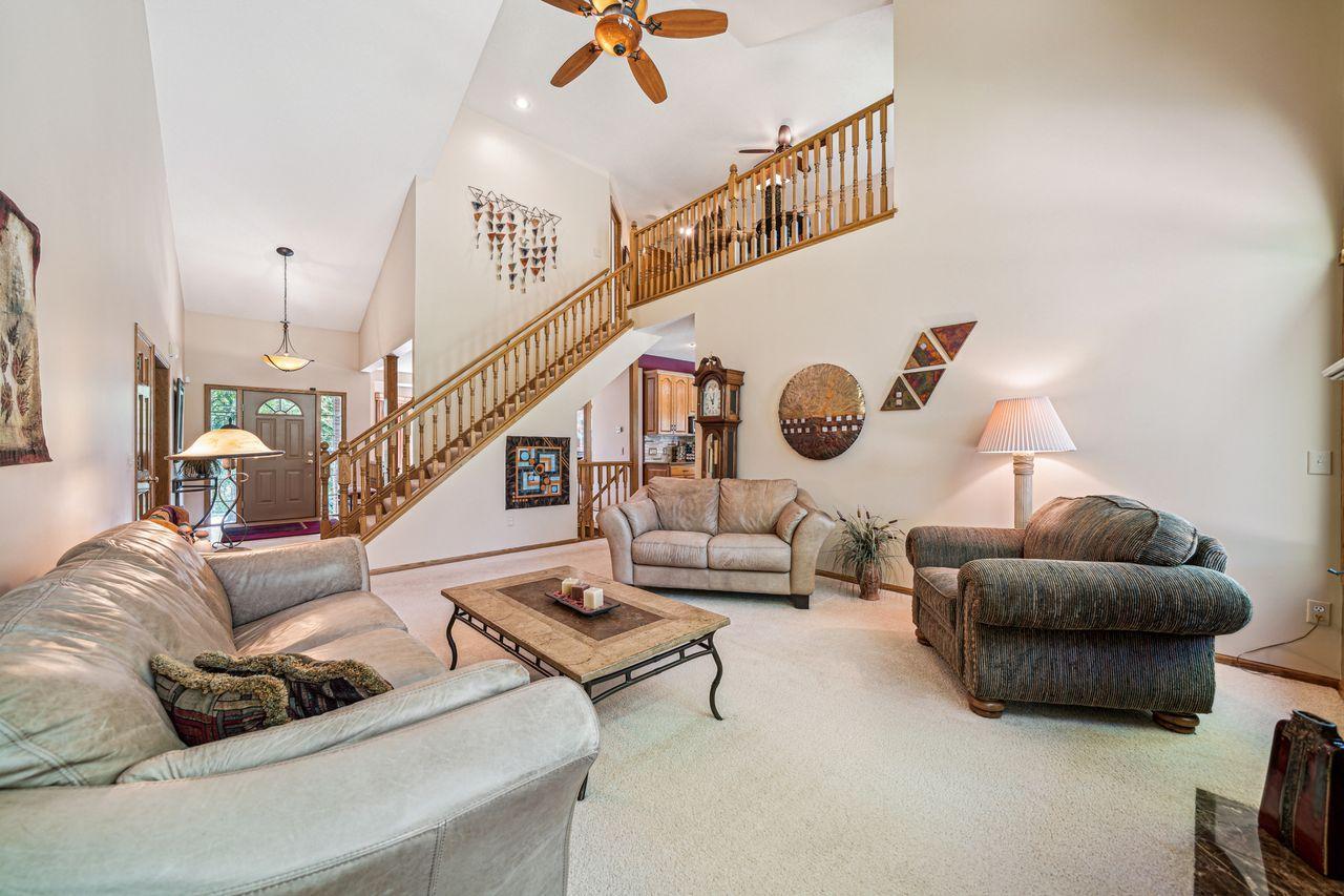 View back towards stairs to upper level with 2 additional bedrooms, full bathroom and sitting area