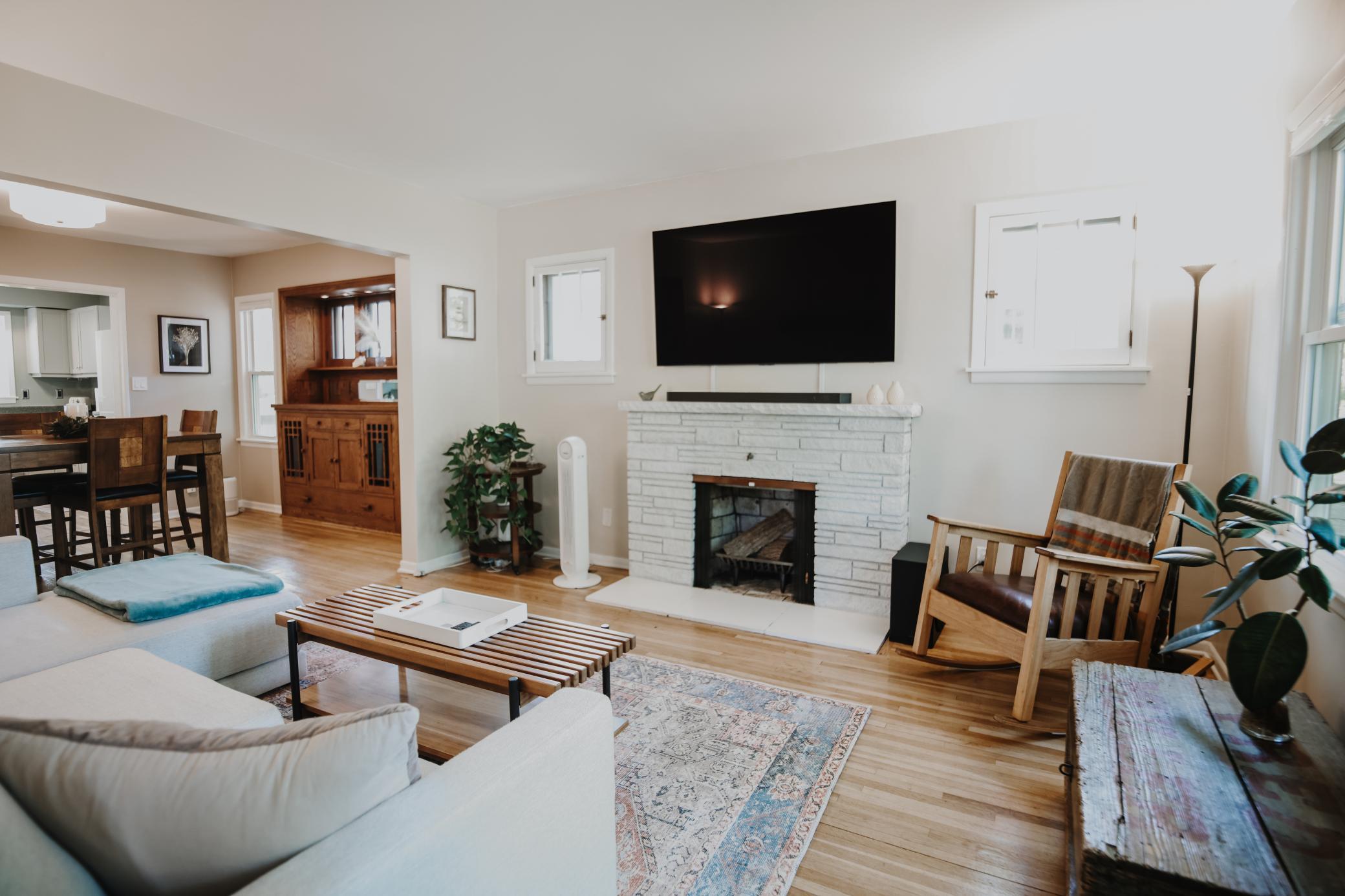 Living room with fireplace & hardwood floors.