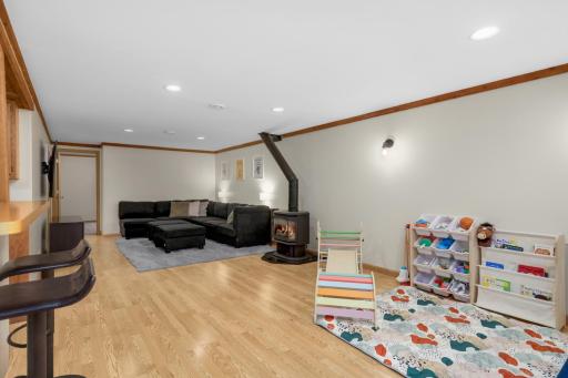 Down the stairs to the lower level family room, playroom and bar!