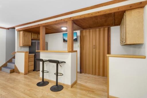 Just beyond the bar is additional storage and laundry.