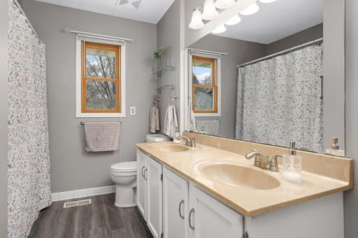 Full bath with dual vanities on the main level.