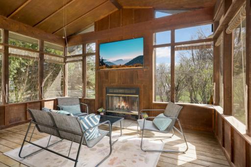THIS is where you'll be spending your spring, summer and fall! Incredible vaulted three-season porch with fireplace.