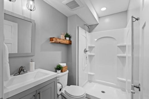 Stylish lower level bathroom featuring a walk-in shower and fresh contemporary design