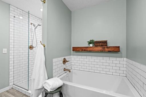 Spa-inspired primary bath with a soaking tub, oversized tiled shower, and timeless modern design.