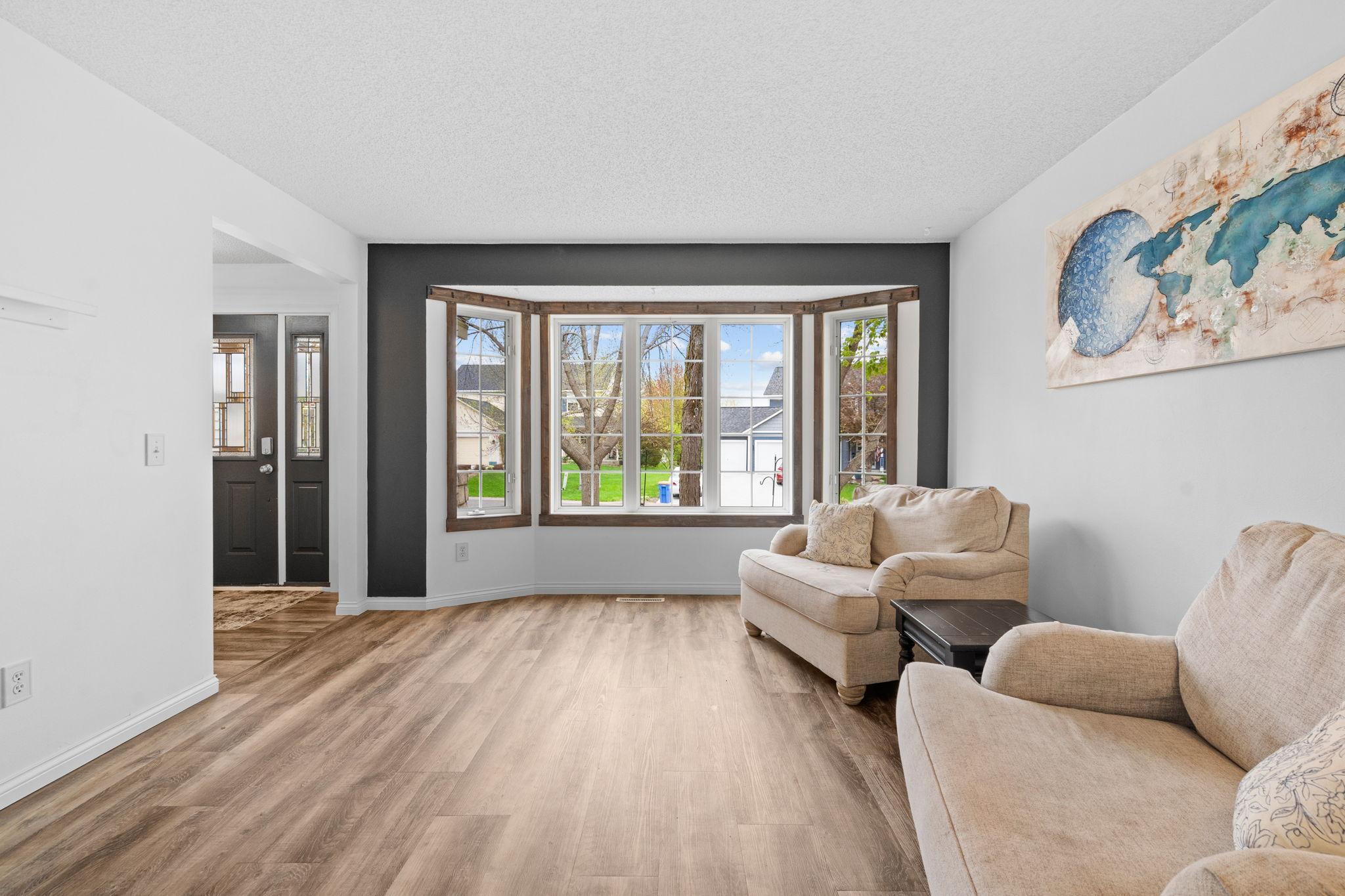 Classic formal living room off the front entrance offering additional space to relax, host, or create a cozy sitting area.
