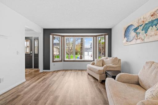 Classic formal living room off the front entrance offering additional space to relax, host, or create a cozy sitting area.