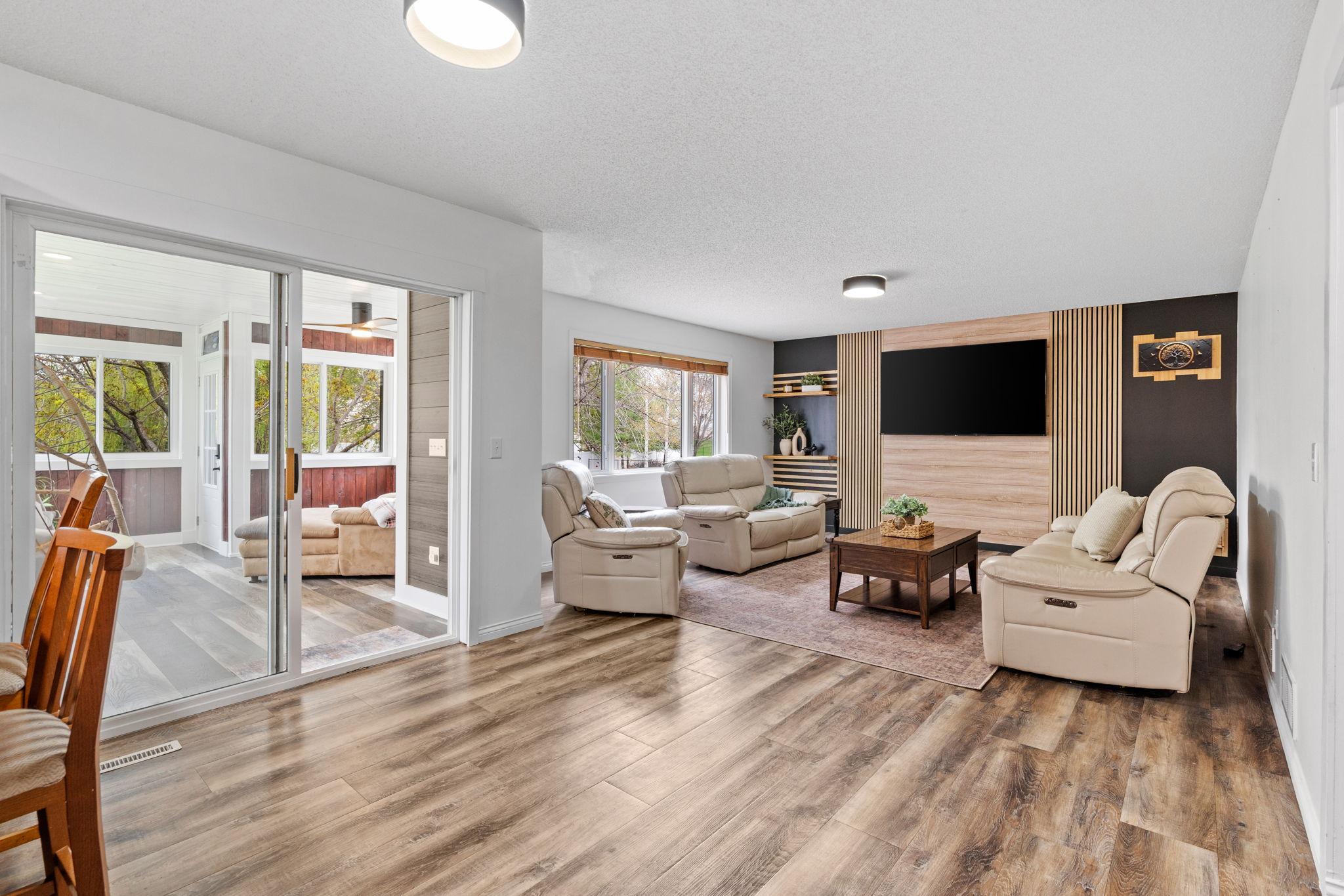 Spacious living area with an open-concept layout and seamless connection to the porch and kitchen.