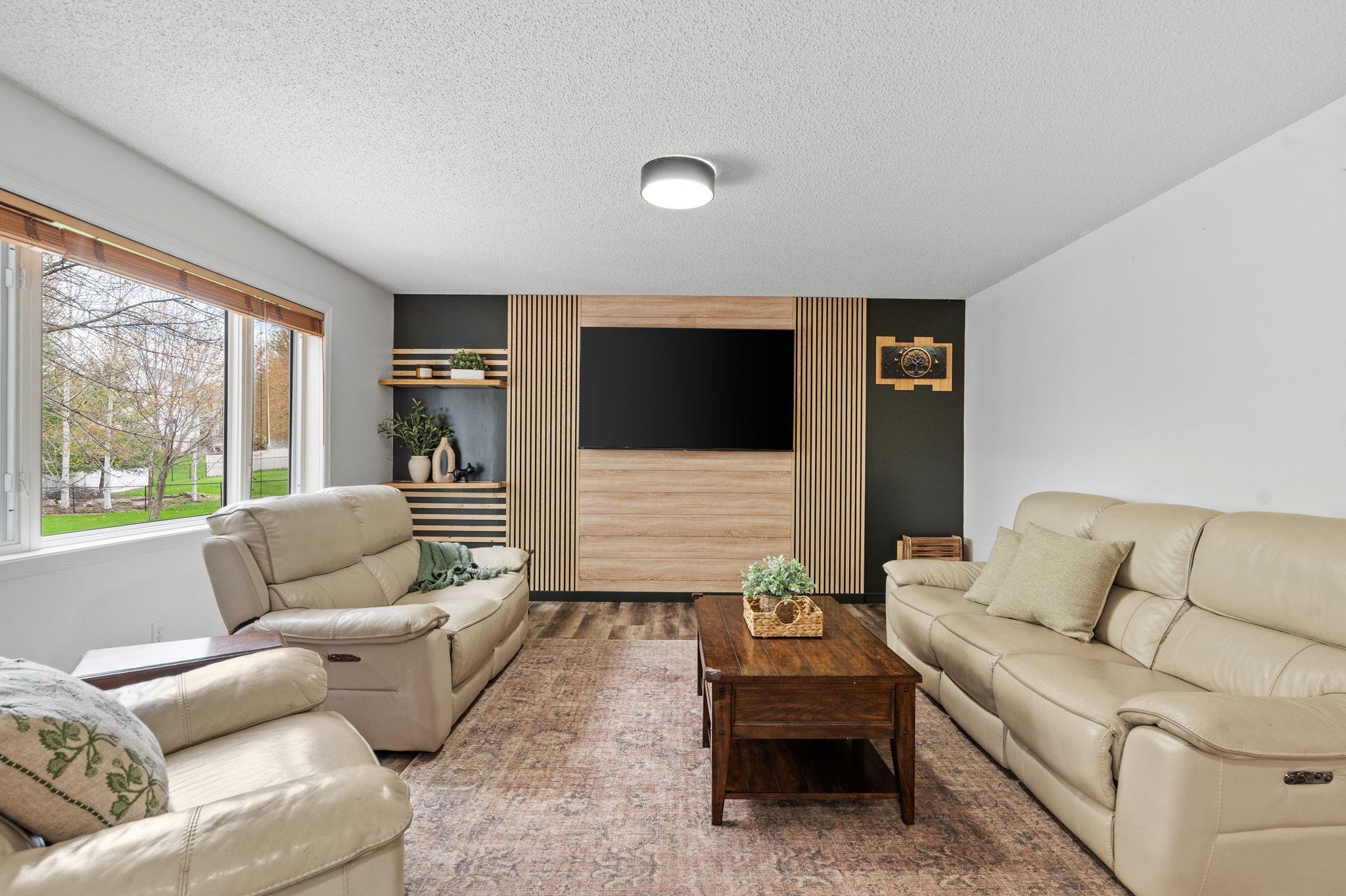 Custom accent wall creates a stunning focal point for movie nights, relaxing, or entertaining guests.
