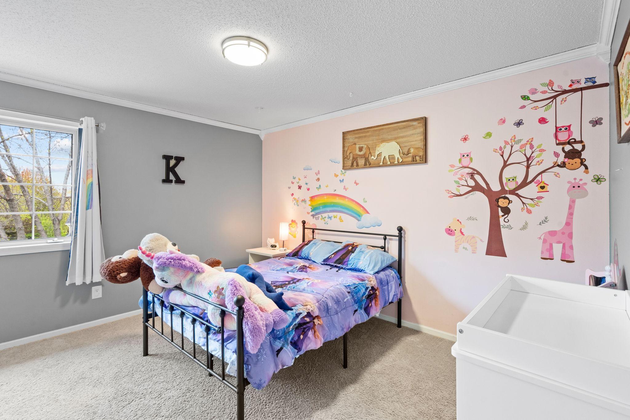 Cheerful and spacious bedroom with whimsical details, soft natural light, and plenty of room to grow.