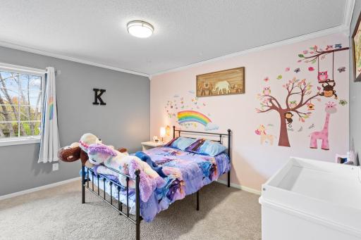 Cheerful and spacious bedroom with whimsical details, soft natural light, and plenty of room to grow.