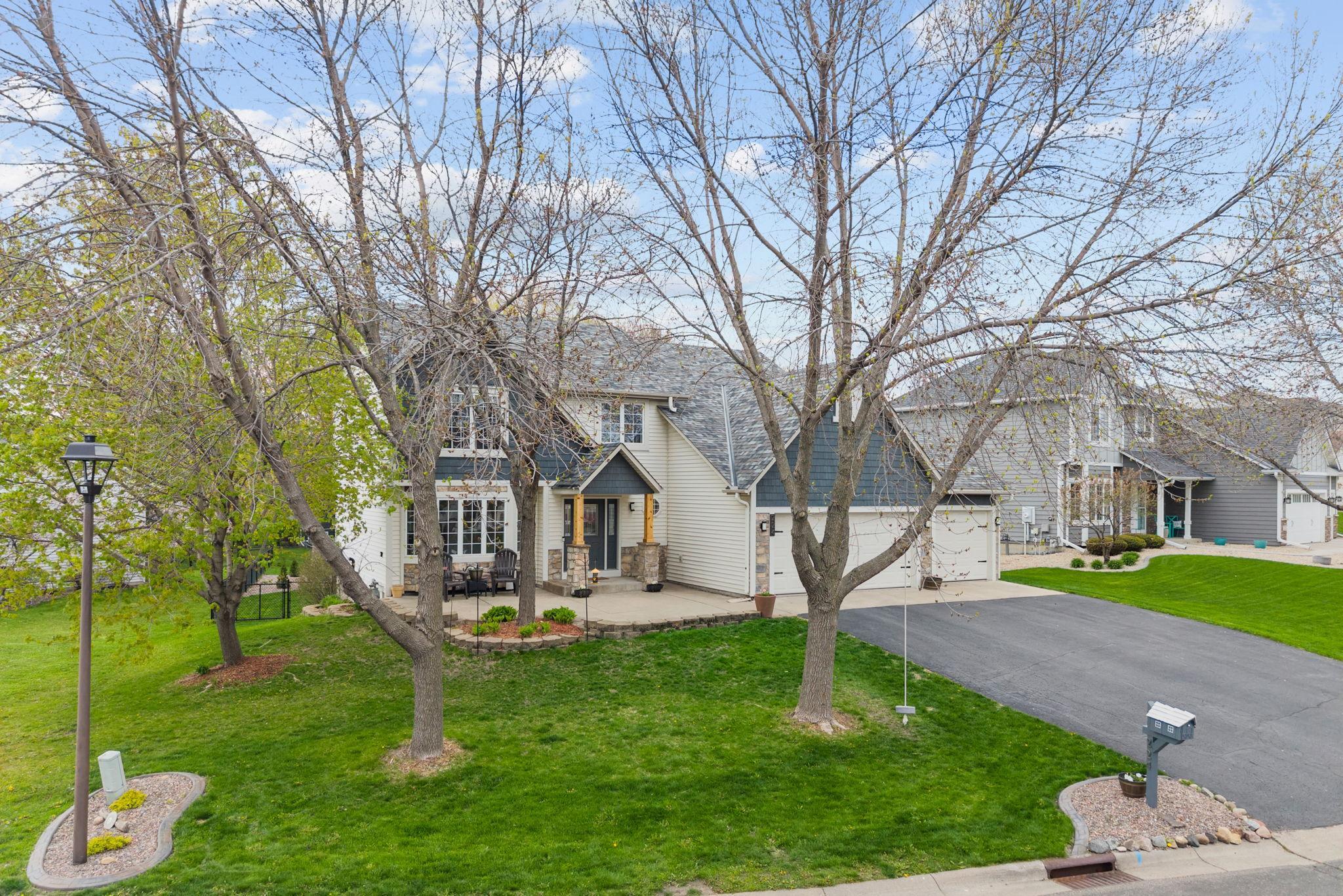 Nestled among mature trees, this home combines warmth, privacy, and standout curb appeal