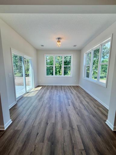The morning room, with views of your wooded 0.24 acre lot! Sliding door leads to your patio with a cedar privacy fence.