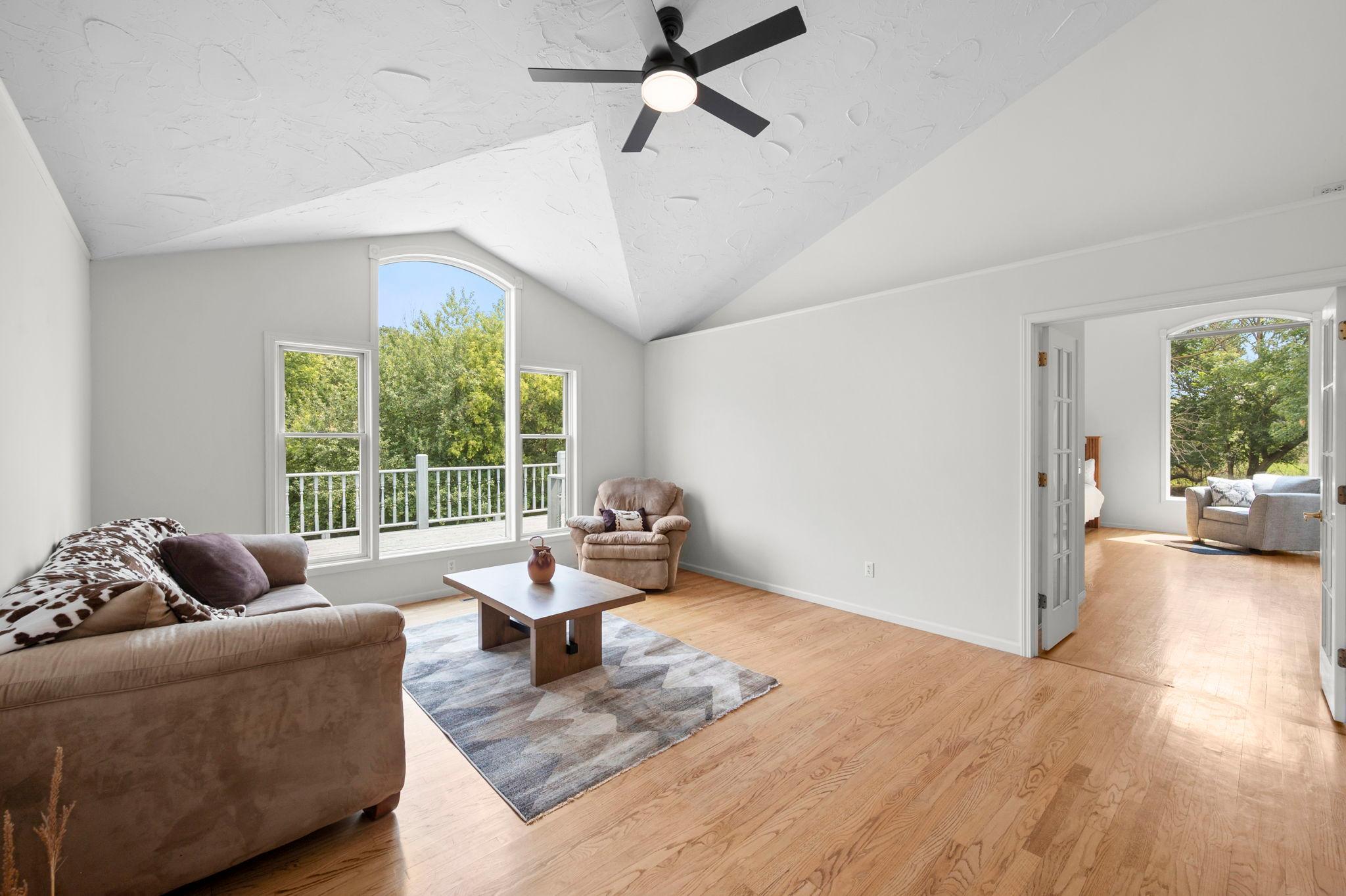 Open and bright living area with windows to overlook your spacious back porch & back acreage.