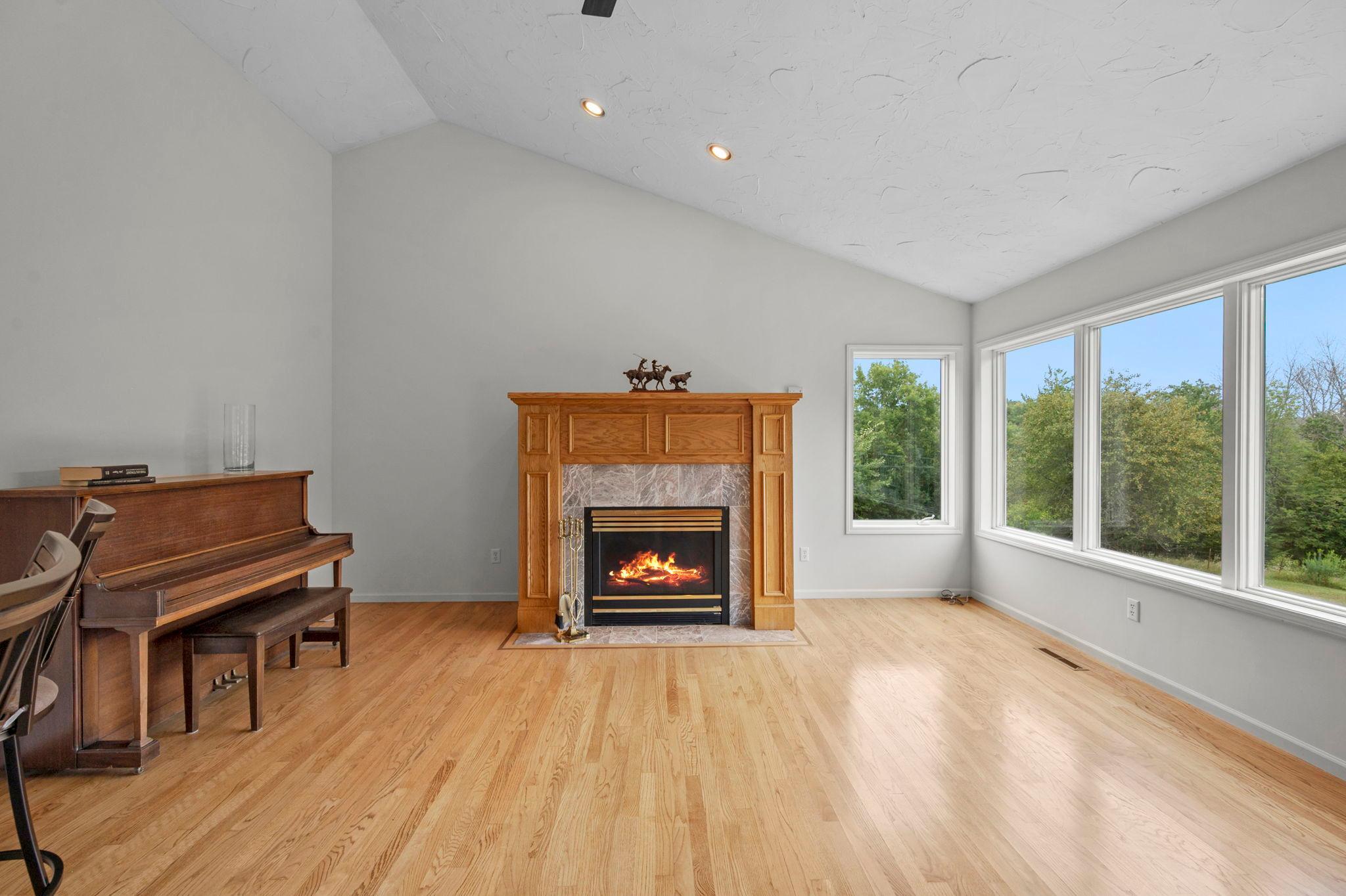 Your open space off the kitchen with propane fireplace, vaulted ceilings and windows, windows, windows!