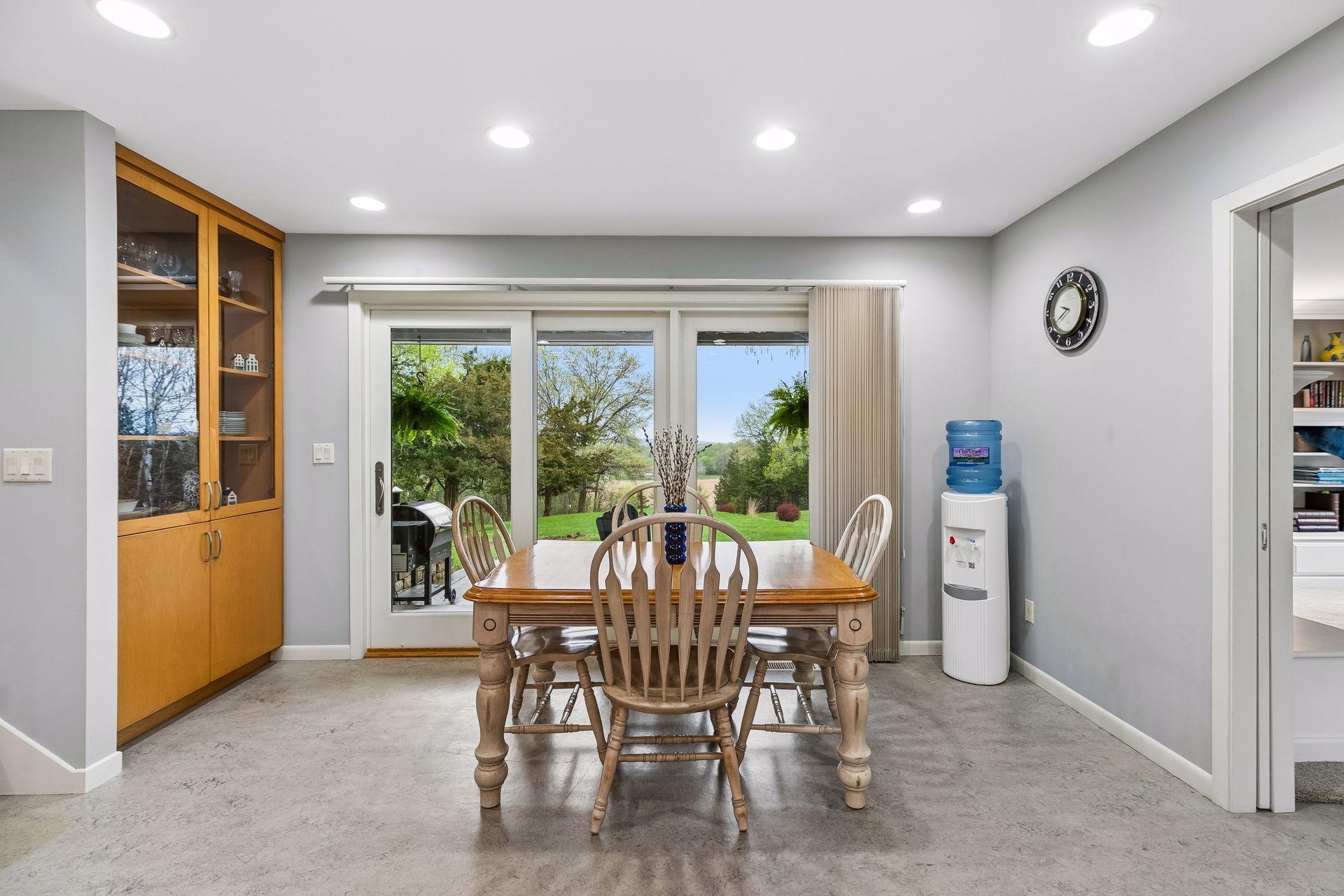 Bright dining space offering linoleum flooring, recessed lighting, built-in storage, and convenient access to the front patio through a sliding door.