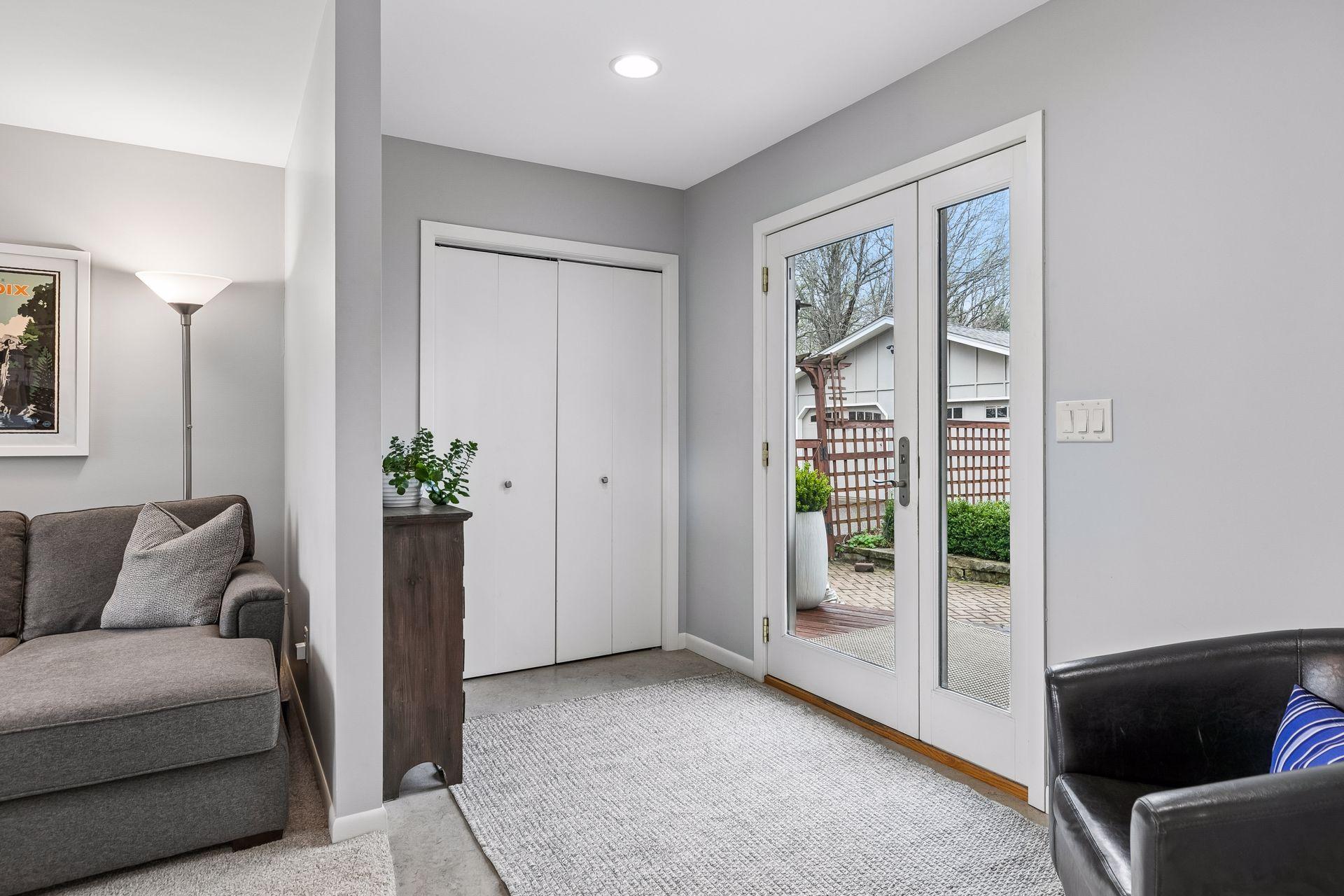 Entry from the patio leads into the foyer with linoleum floors, recessed lighting, and a practical coat closet for everyday use.
