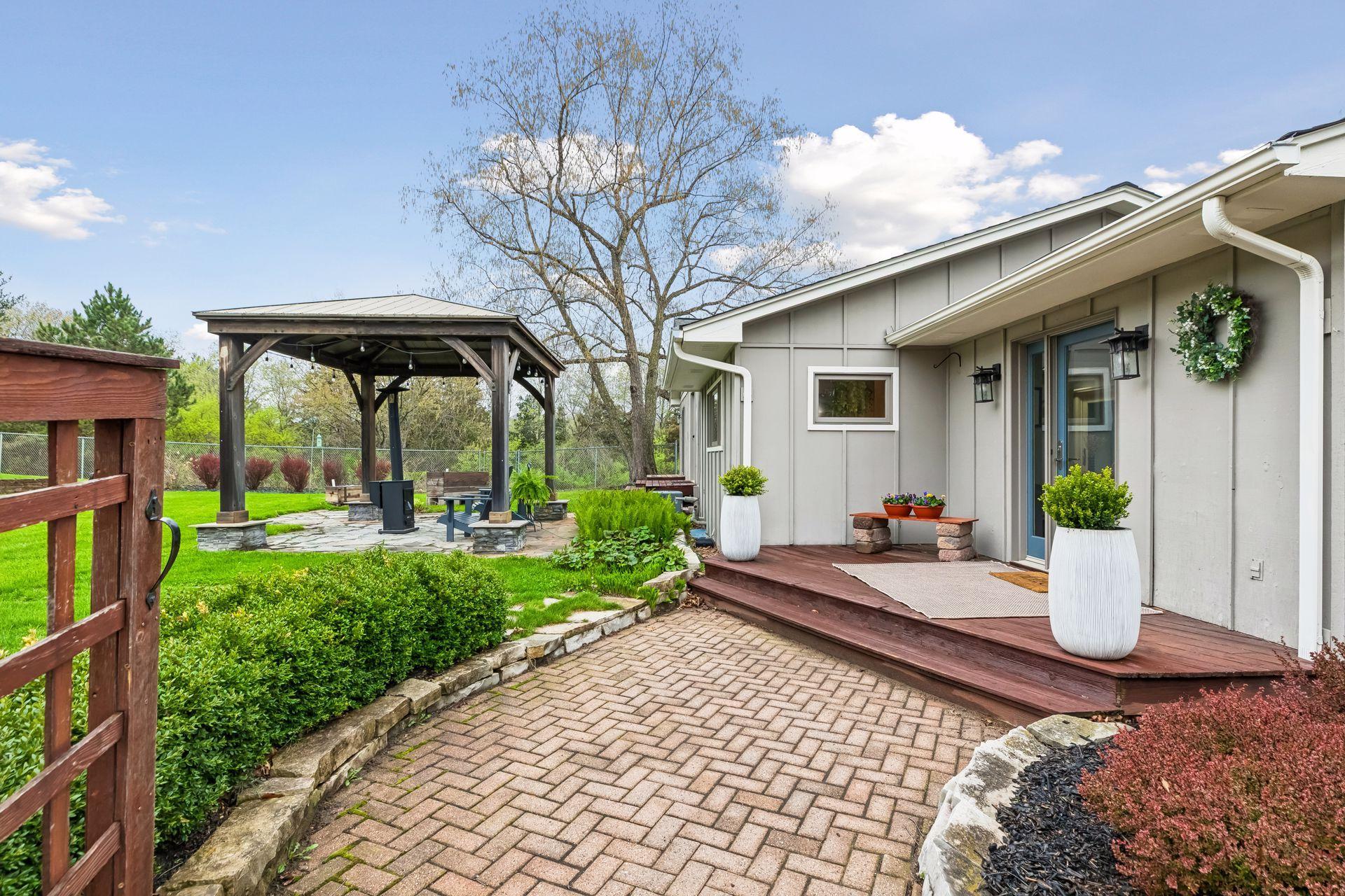Beautiful brick pavers leading up to a cozy deck.