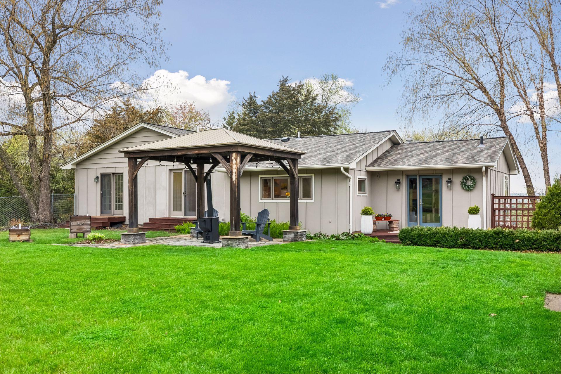 Enjoy late afternoon sun on this south facing flagstone patio, comfortably shaded by a pergola; perfect for relaxing or outdoor gatherings.