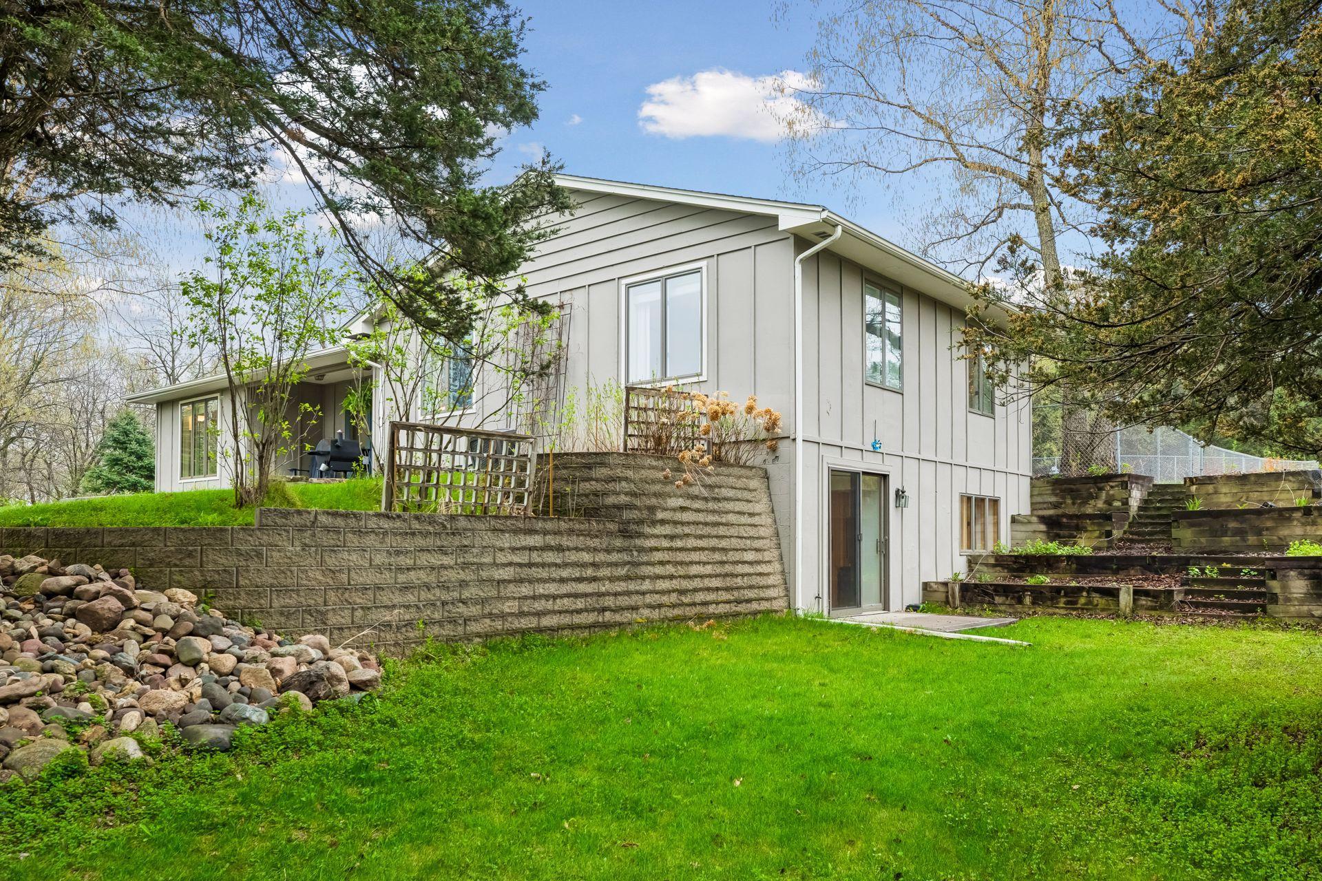 Beautifully maintained, the extensive landscaping adds character, structure, and appeal throughout the outdoor spaces.