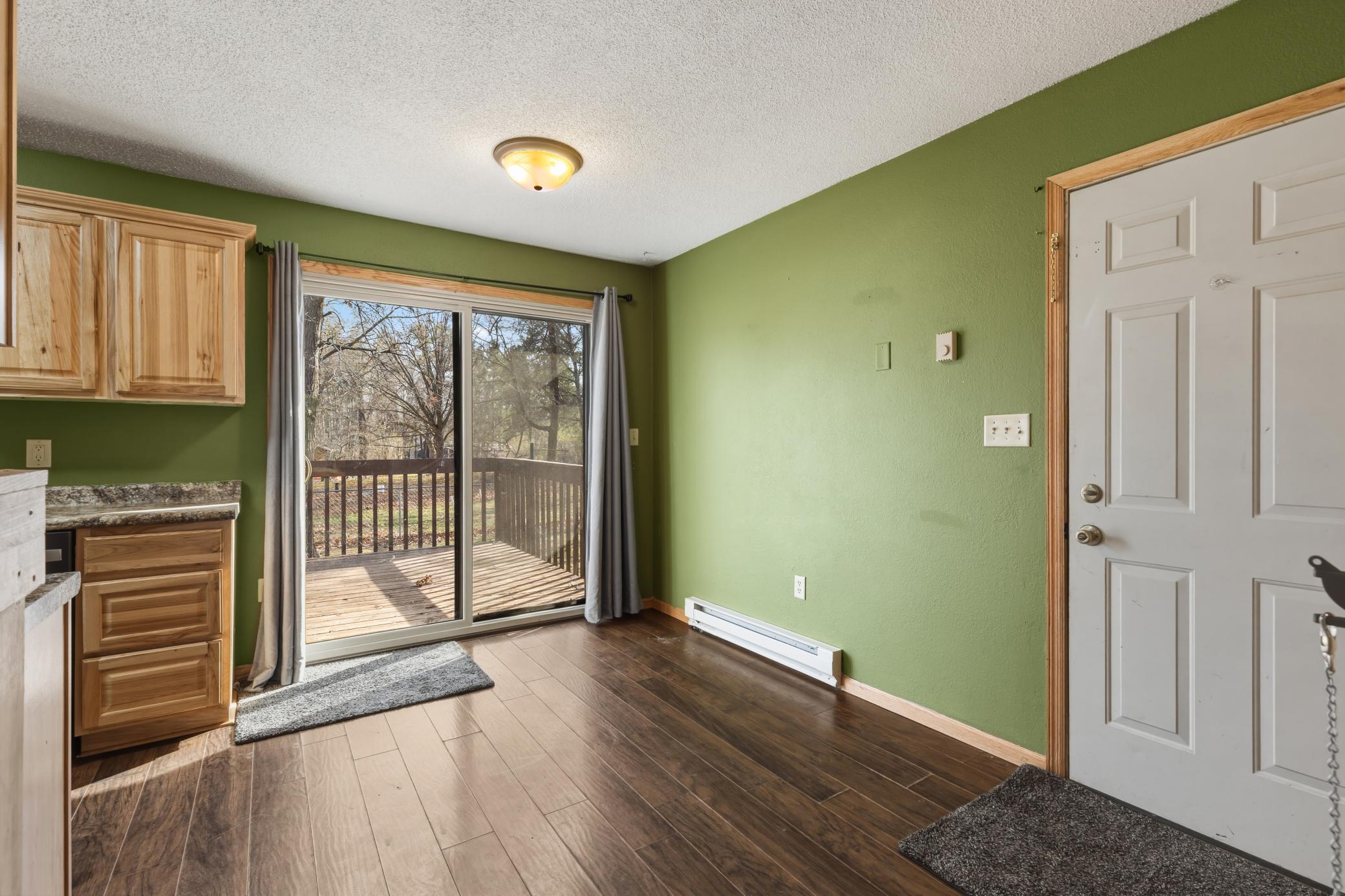 The dining area is conveniently located next to the kitchen with a sliding door leading to the deck