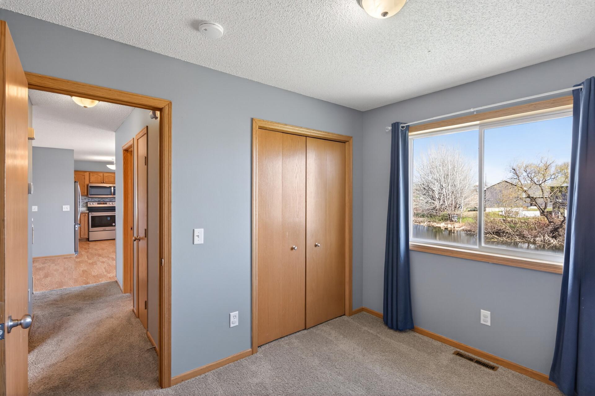 Second bedroom upstairs, overlooks pond and walking trail