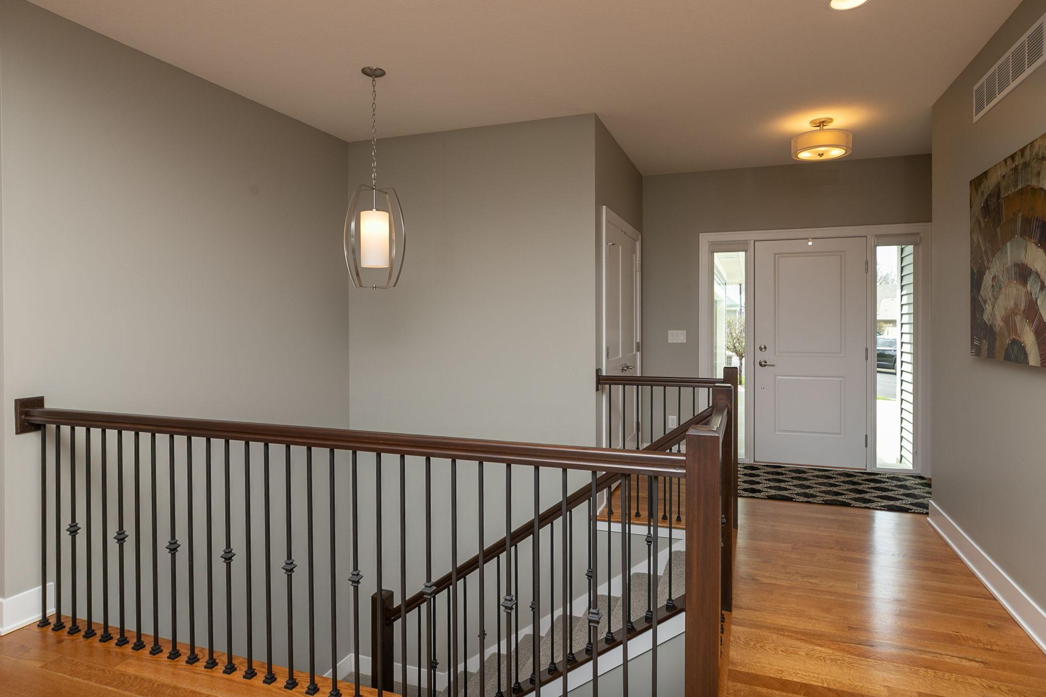 Attractive open staircase with iron spindles keeps the space open