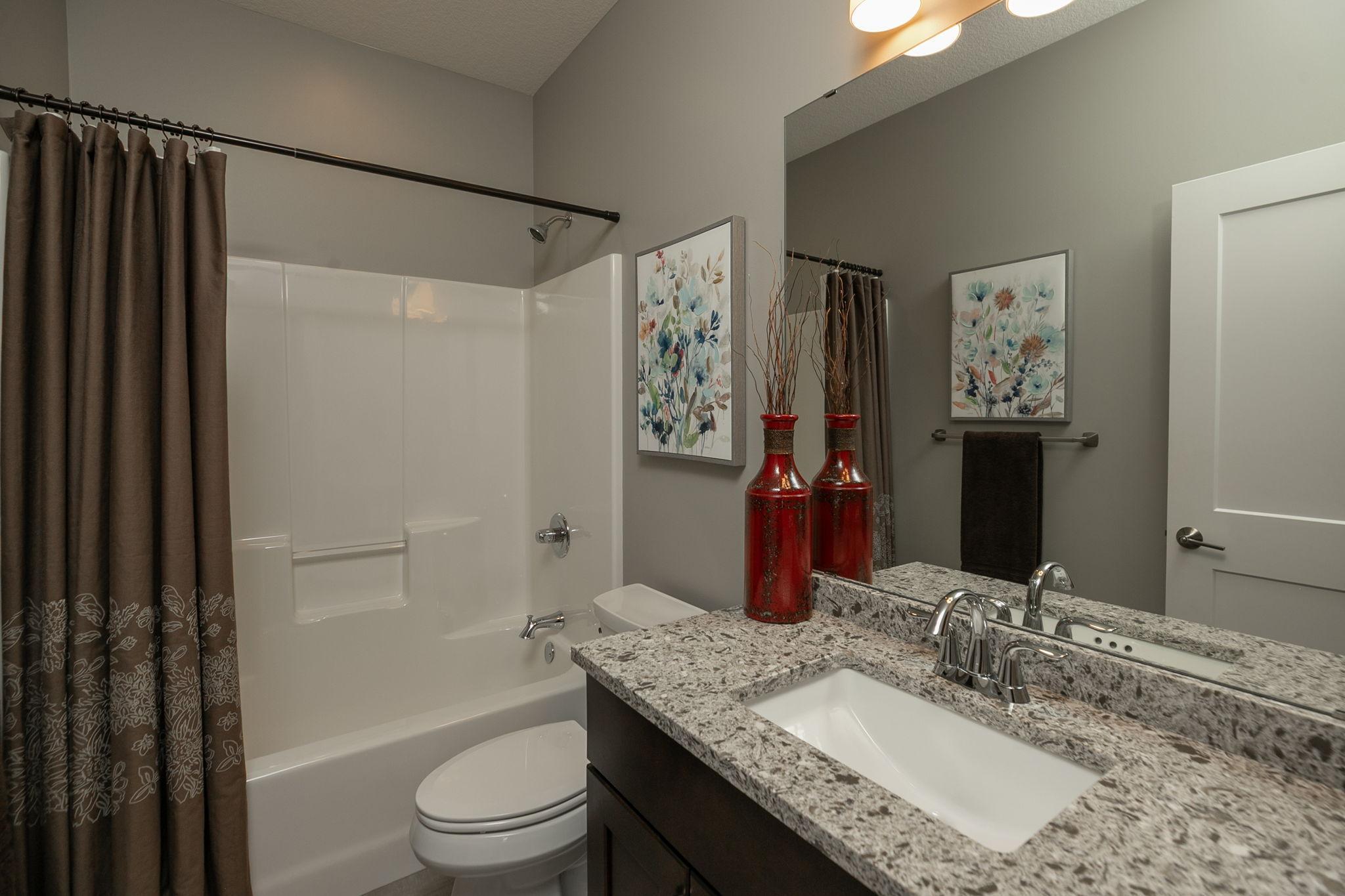 Full bath and granite topped vanity in second main floor bath