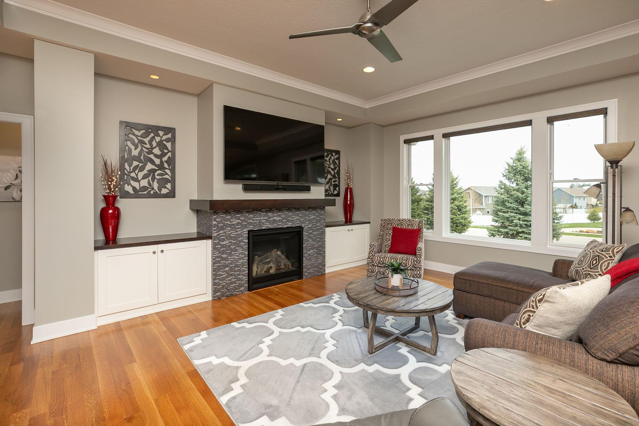 Sun-filled great room w/crown molding accenting the tray ceiling and large picture window